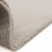 silver plain shaggy rug partial fold on white floor