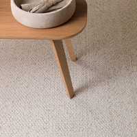 grey plain flatweave rug closeup with a table