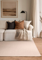 ivory plain flatweave rug in a living room with matching decor