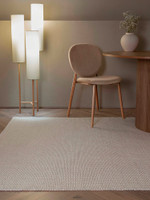 ivory plain flatweave rug in a living room with matching decor