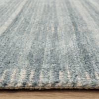 blue plain rug closeup edge on wood floor