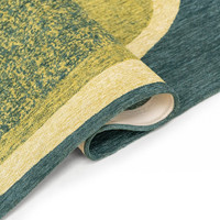 green abstract eco rug folded on white floor