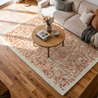 orange abstract rug in a bedroom with matching decor
