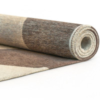 brown abstract rug rolled on white floor