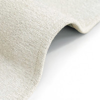 beige abstract rug folded on white floor