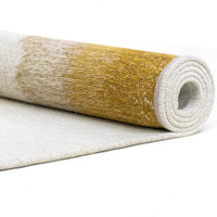 gold abstract rug rolled on white floor