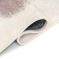 purple abstract rug folded on white floor