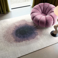 purple abstract rug in a living room with matching decor