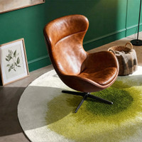 green abstract rug in a living room with matching decor