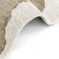 beach abstract eco rug partially folded on white floor