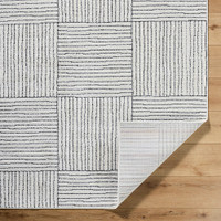 ivory black scandi rug corner fold on wood floor