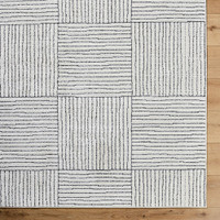 ivory black scandi rug closeup corner on wood floor