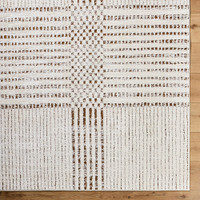 brown ivory scandi rug closeup corner on wood floor