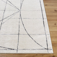 black ivory scandi rug closeup corner on wood floor