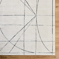 black ivory scandi rug closeup corner on wood floor