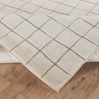 taupe ivory scandi rug corner fold on wood floor