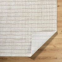 ivory taupe rug corner fold on wood floor