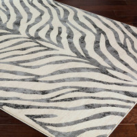charcoal zebra pattern rug in a room with matching decor