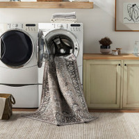 brown traditional rug in washing machine in a utility room