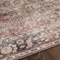 brown traditional rug closeup detail on wood floor
