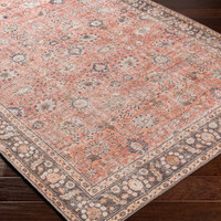 orange traditional rug closeup corner on wood floor