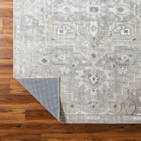 brown traditional rug corner folded on wood floor
