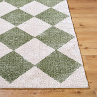 green diamond shaggy rug closeup corner on wood floor