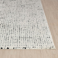 ivory black scandi rug closeup corner on wood floor