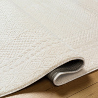 ivory off-white scandi rug folded on wood floor