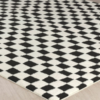 ivory black scandi rug closeup corner on wood floor