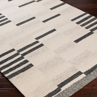 beige striped wool rug closeup corner on wood floor