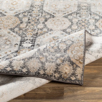 black traditional rug folded on wood floor