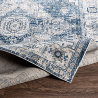 blue traditional rug folded on wood floor