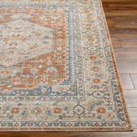 orange traditional rug closeup corner on wood floor