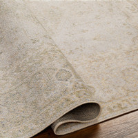 camel traditional rug folded on wood floor