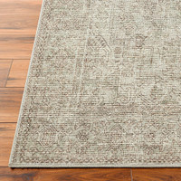 sage traditional rug closeup corner on wood floor