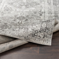 grey abstract rug closeup folded on wood floor