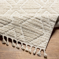 beige berber geometric rug corner fold on wood floor