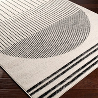 mono geometric rug closeup corner on wood floor
