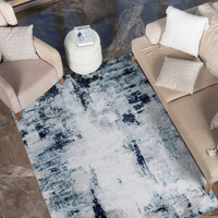 navy abstract rug in a room with matching decor