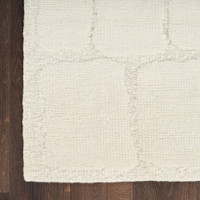 ivory wool rug closeup corner on wood floor