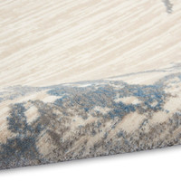 ivory grey blue calvin klein rug partially rolled on white floor