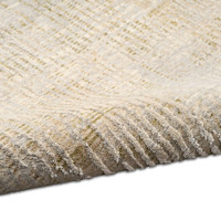 grey calvin klein rug partially rolled on white floor