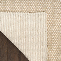 ivory taupe rug closeup folded on white background