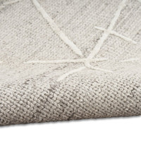 grey calvin klein rug partially rolled on white floor