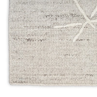 grey calvin klein rug closeup corner on white background