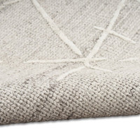 grey calvin klein rug partially rolled on white floor