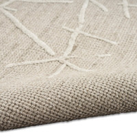 taupe calvin klein rug partially rolled on white floor