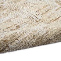 mocha ivory calvin klein rug partially rolled on white floor
