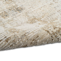 natural grey calvin klein rug partially rolled on white floor